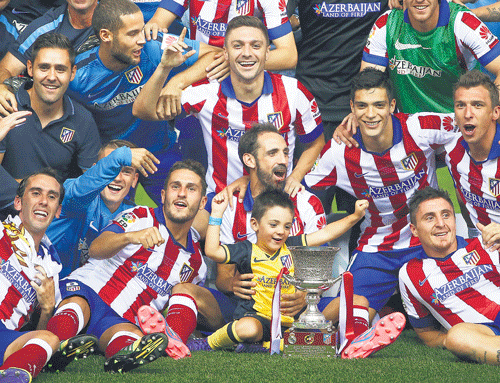 Atletico Madrid players celebrate with the Spanish Super Cup after beating Real Madrid on Friday. AP