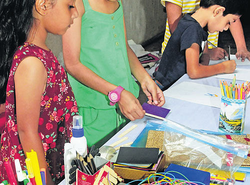 Reuse: Children try their hands at making useful materials out of waste at a workshop in  Bangalore on Sunday. dh photo