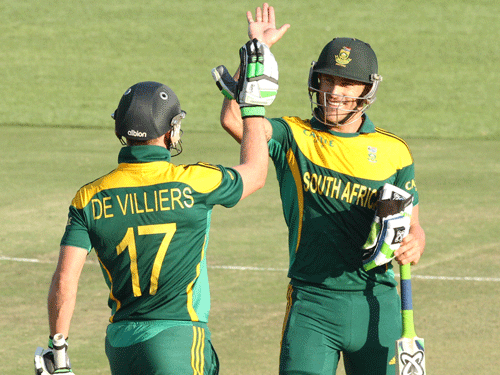 South African player Faf du Plessis, right, celebrates with AB de Villiers after scoring 100 runs during the cricket One Day International match against Australia in Harare Zimbabwe Wednesday, Aug. 27, 2014. The two teams are in Zimbabwe for a triangular ODI series with Zimbabwe. AP Photo