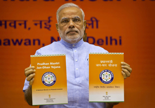 Prime Minister Narendra Modi releases publications at the launch of Pradhan Mantri Jan Dhan Yojana in New Delhi on Thursday. AP photo