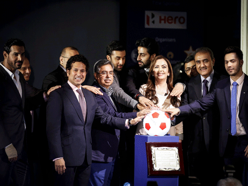 Club owners and representatives of sponsors and organisers take a pledge over a soccer ball replica during the emblem-unveiling ceremony of Indian Super League in Mumbai August 28, 2014. REUTERS