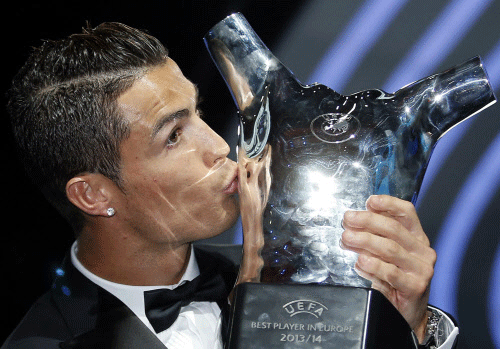Real Madrid's Cristiano Ronaldo kisses his Best Player UEFA 2014 Award during the draw ceremony for the 2014/2015 Champions League Cup soccer competition at Monaco's Grimaldi Forum in Monte Carlo. Reuters photo