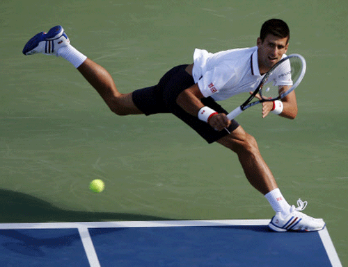 ovak Djokovic, of Serbia, returns a shot to Paul-Henri Mathieu, of France, during the second round of the 2014 U.S. Open tennis tournament. AP photo