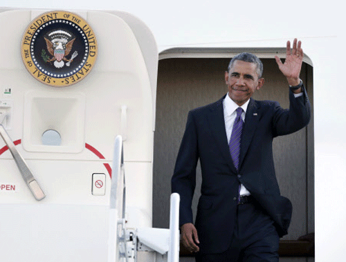 President Obama waves to a crowd gathered on the tarmac shortly after arriving at T.F. Green Airport in Warwick. AP photo