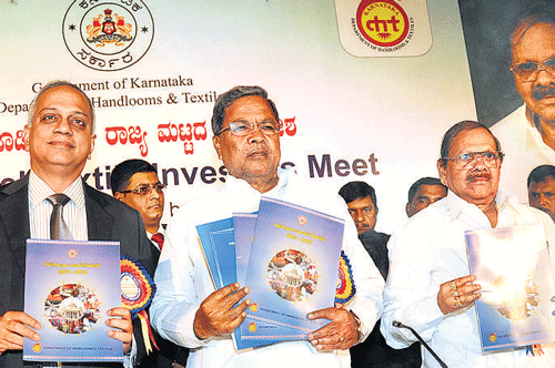 Chief Minister Siddaramaiah( 2nd from left) releasing the new textile policy, at the textile investors meet organised by the Department of Handlooms & Textiles in ssociation with FICCI, in Bangalore on Saturday. FICCI co-chairman Anand Sudarshan, Textiles Minister Baburao Chinchansur and Additional Chief Secretary Commerce & Industry Department  K Ratna Prabha are also seen. DH Photo