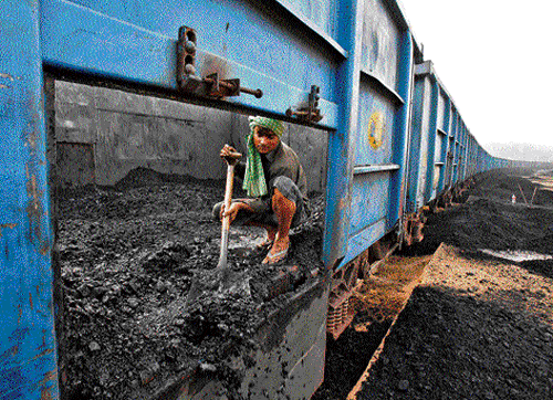 Black future: A worker unloads coal from a goods train at a railway yard in Chandigarh in this July 2014 file photo. Half of India's thermal power stations have less than a week's supply of coal on hand, according to weekly data, the lowest level since mid-2012 when millions of people were left without power in one of the world's worst blackouts. There was a sharp fall in power output on August 28, 2014, from a plant in Gujarat that left India more than 9,000 megawatts short of peak demand, according to two officials at the state grid operator. REUTERS