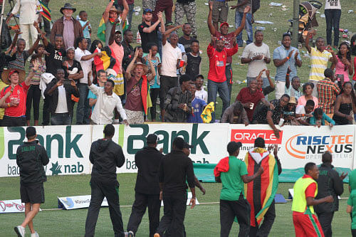 Zimbabwean cricket players do a lap of honor after winning their cricket One Day International match against Australia by 3 wickets, in Harare, Zimbabwe, Sunday, Aug. 31, 2014 AP photo