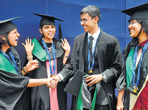 Top gold medalists (fromleft) Sakshi Arvind, Juhi Gupta, Abhinav Sekhri and Vinodini Srinivasan congratulate each other at the 22nd annual convocation of the National LawSchool of India University in Bangalore on Sunday. DH PHOTO