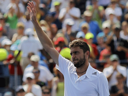 Gilles Simon of France waves after his win over David Ferrer of Spain during their match at the 2014 U.S. Open tennis tournament in New York. Reuters photo