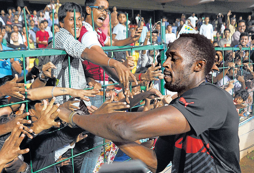 Usain Bolt took some time off to interact with fans during an exhibition cricket match at the M&#8200;Chinnaswamy stadium on Tuesday. DH