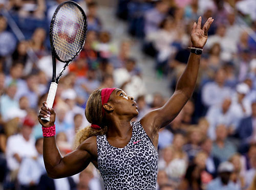 Serena Williams of the U.S. serves to Flavia Pennetta of Italy in their quarter-final women's singles match at the 2014 U.S. Open tennis tournament in New York, September 3, 2014. REUTERS