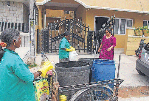 litter-free locality: Workers lift waste from the neighbourhood. DH PHOTO