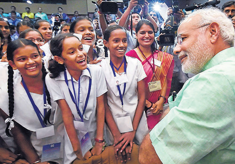 Prime Minister Narendra Modi talks to students after addressing them on the occasion of Teachers' Day in New Delhi on Friday. PTI