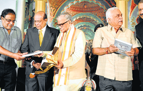 BJP leader Murli Manohar Joshi gives a copy of a book on former DGP, B N Garudachar, (second from left) to minister  M H Ambareesh on Sunday. dh photo