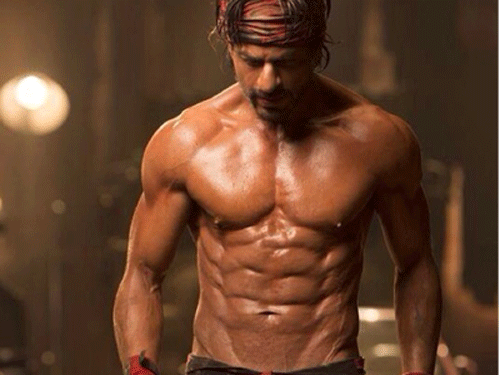 Bollywood superstar Shah Rukh Khan has unveiled his new chiselled body and eight pack abs, which is part of his look for upcoming film 'Happy New Year', directed by Farah Khan.