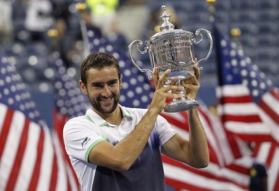 1 OF 3. Marin Cilic of Croatia poses with his trophy after defeating Kei Nishikori of Japan in their men's singles final match at the 2014 U.S. Open tennis tournament in New York, September 8, 2014.