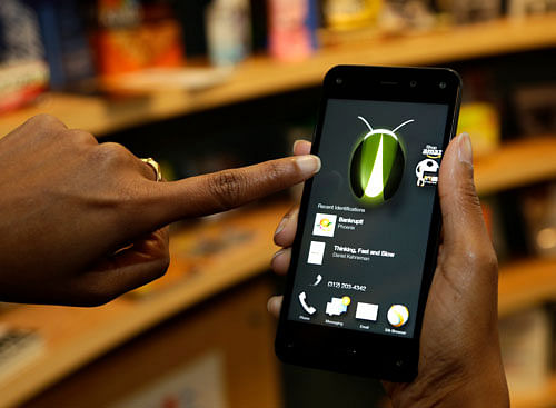 Two months after the launch of its maiden smartphone, global eCommerce giant Amazon has cut the price of its flagship Fire Phone by USD 198 to 99 cents. AP file photo