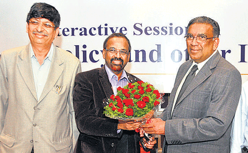 BCIC Past President N Ahmedali (second from right) hands over a bouquet to Labour Department Commissioner D S Vishwanath during the interactive session on labour policy and related issues in Bangalore on Tuesday. Also seen are BCIC Chairman of HR Expert Committee T R Parasuraman and Secretary General T S Sampath Kumar. DH Photo