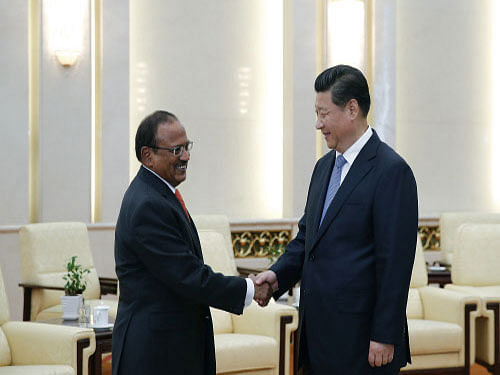 Chinese President Xi Jinping shakes hands with India's National Security Adviser Ajit Doval at the Great Hall of the People in Beijing. Reuters photo