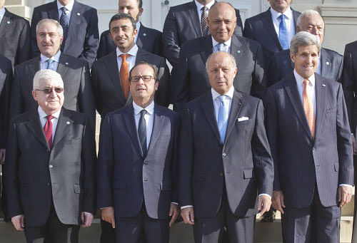 Top row from left, Jordanian Foreign Minister, Sheikh Sabah Khaled al Hamad, Foreign Minister of United Arab Emirat sheik Abdullah Bin Zayed al Nahyan, unidentified, Spanish Foreign Minister Jose Manuel Garcia-Margallo, front row from left, Iraqi President Fouad Massoum, French President Francois Hollande, French Foreign Minister Laurent Fabius and U.S. Secretary of States John Kerry, pose for a group photo at the French Foreign ministry in Paris, Monday Sept. 15, 2014, prior to a meeting on the Islamic State group. Diplomats from around the world are in Paris pressing for a coherent global strategy to combat extremists from the Islamic State group. AP