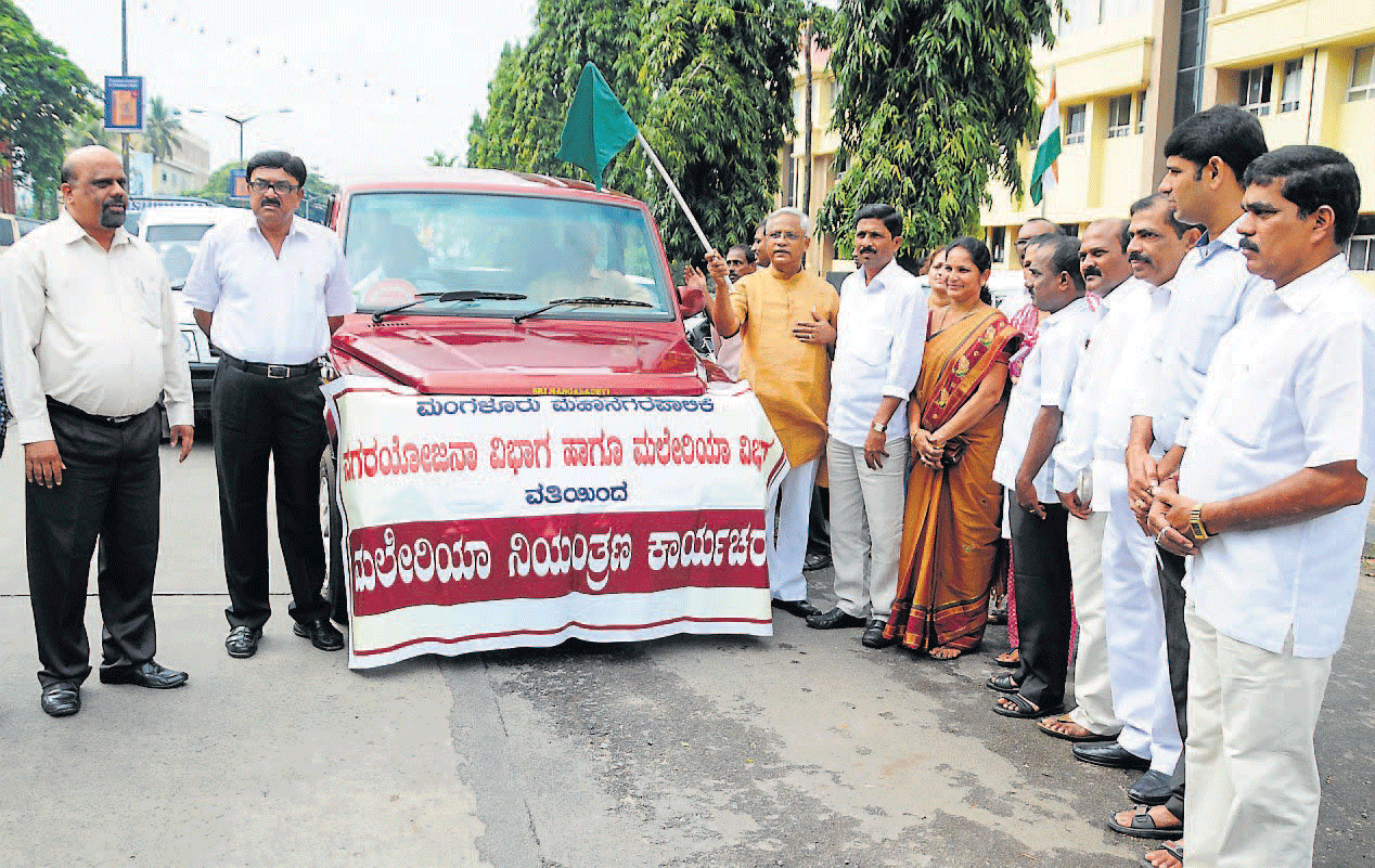 MLA J R Lobo flags off the vehicle to launch the malaria controlling drive at Mangalore City Corporation premises on Monday. Mayor Mahabala Marla, Deputy Mayor Kavitha and others look on. DH Photo