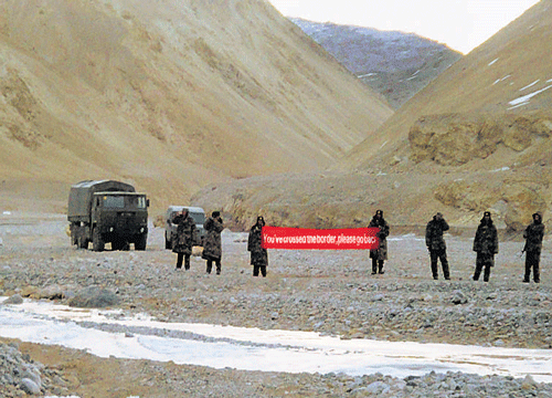 In this May 5, 2013 photo, Chinese troops hold a banner which reads ''You've crossed the border, please go back'' in Ladakh. AP file Photo
