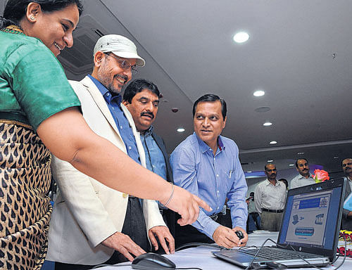 Transport department Additional Chief Secretary P B Ramamurthy launches push SMS  service in Bangalore on Wednesday. BMTC MD Ekroop Kaur, Transport Department  Commissioner Ramegowda and Joint Commissioner Narendra Holkar are seen. DH Photo