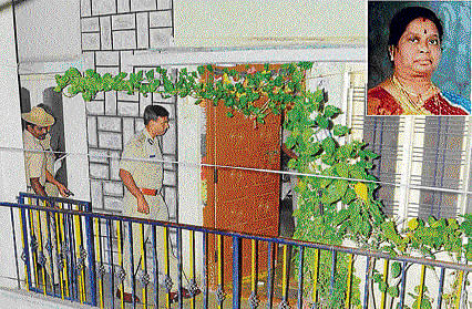 Police inspect Mailavathi's (inset) house.