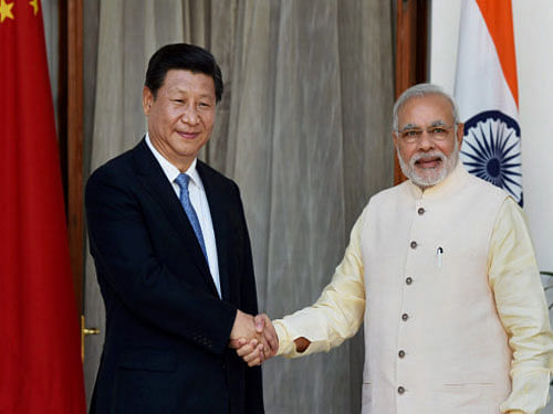 Prime Minister Narendra Modi shakes hands with Chinese President Xi Jinping before a meeting at the Hyderabad House in New Delhi. As many as 12 accord documents were exchanged between India and China. PTI photo