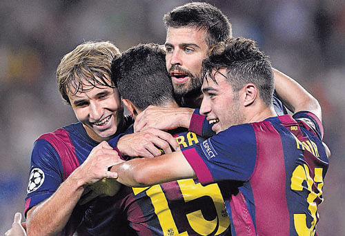 Barcelona's Gerard Pique (centre) is congratulated by team-mates after scoring against APOEL&#8200;Nicosia during their Champions League match on Wednesday. Reuters Image