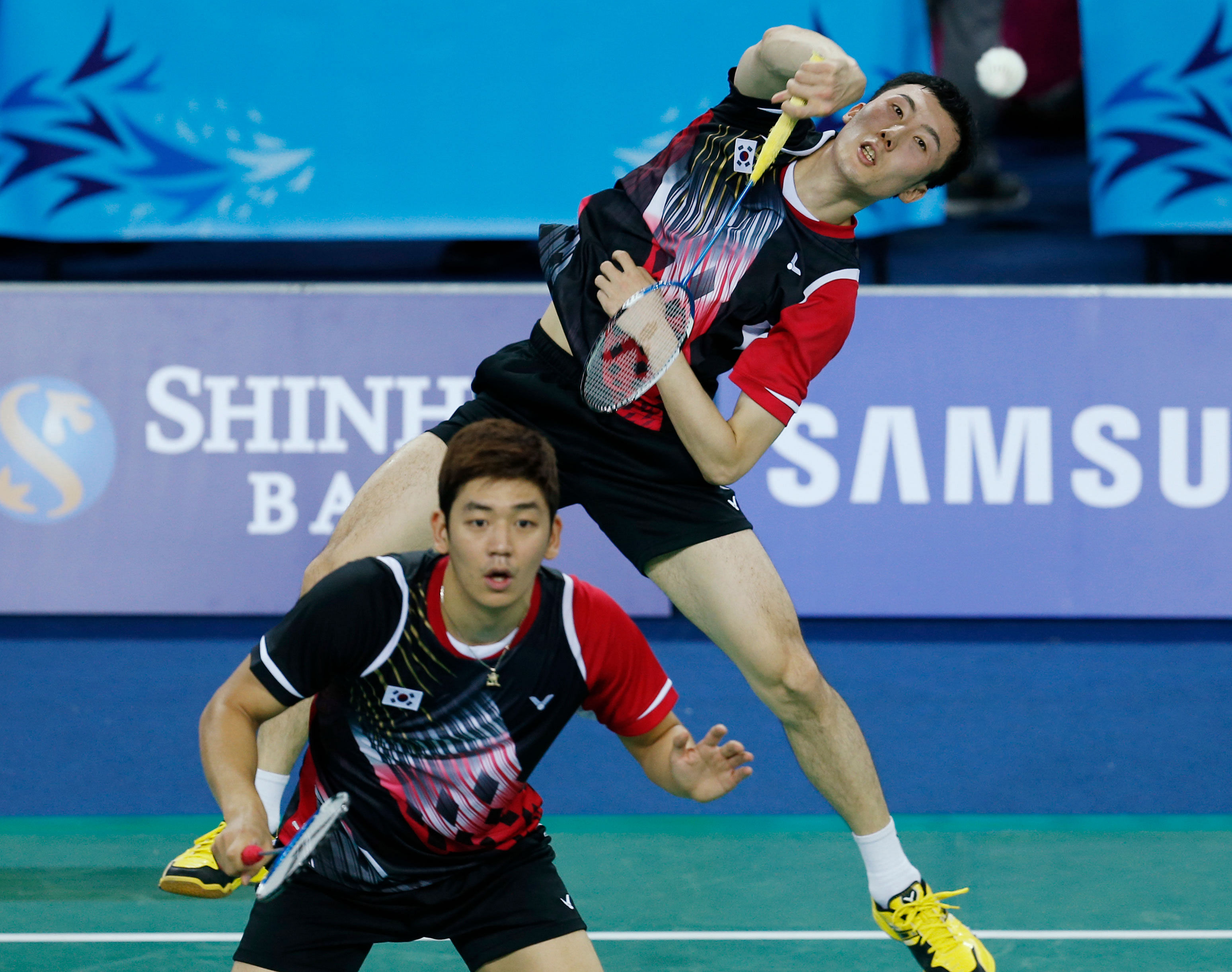 South Korea's Yoo Yeonseong, back, and Lee Yongdae return a shot to India 's Sumeeth Reddy Buss and Manu Attri during the Men's Badminton team round of 16 match at the 17th Asian Games in Incheon, South Korea Saturday, Sept. 20, 2014. AP Photo