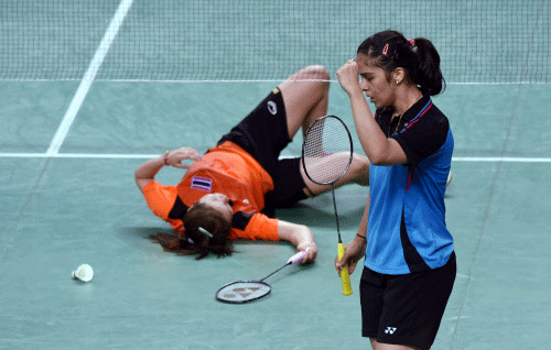 India's Saina Nehwal celebrates after a scoring a point against Thailand's R Invtanon during their Badminton singles quaterfinal match at Asian Games 2014 in Inchoen, South Korea on Saturday. PTI Photo