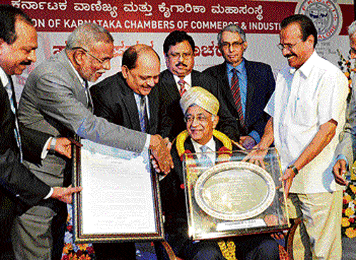 Bharat Forge  Chairman  and MD Baba Kalyani receives the Sir M Visvesvaraya Memorial Award 2014 instituted by FKCCI from Union Minister for Railways D V Sadananda Gowda  in Bangalore on Saturday. Also seen is FKCCI President S Sampathraman (right). DH PHOTO