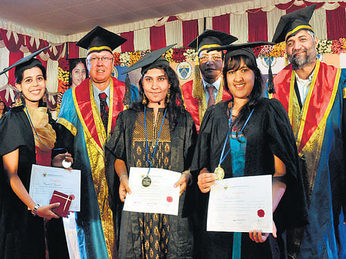 Rank holders strike a pose with dignitaries at the graduation day ceremony of the Dayananda Sagar Institution on Sunday.