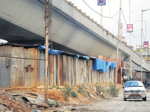 Messy: The temporary shelters below the Domlur flyover. DH Photo by SK Dinesh
