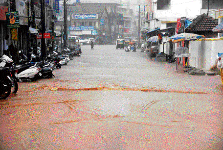 battered: Roads were flooded in Hassan following heavy rain on Wednesday. dh Photo