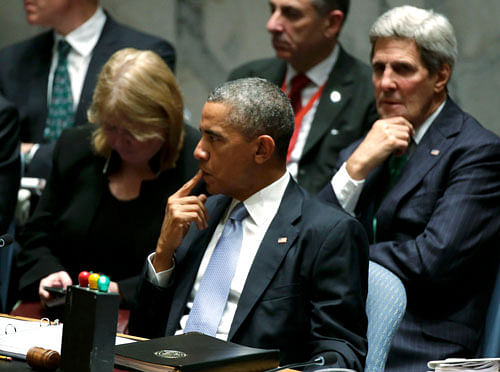 U.S. President Barack Obama (C) sits with Secretary of State John Kerry (R) as the president chairs a meeting of the U.N. Security Council at the 69th United Nations General Assembly in New York, September 24, 2014. The Security Council demanded on Wednesday that all states make it a serious criminal offense for their citizens to travel abroad to fight with militant groups, or to recruit and fund others to do so, in a move sparked by the rise of Islamic State. REUTERS photo