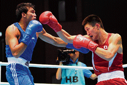 on guard Japan's Masatsugu Kawachi (right) in action against Manoj Kumar in the boxing event. Reuters