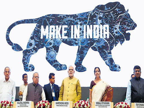 Prime Minister Narendra Modi unveils the logo of 'Make in India' initiative in New Delhi on Thursday. AP