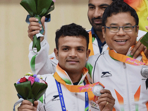 Silver medalist Vijay Kumar , Tamang Pemba,Gurpreet Singh in men's 25m Center pistol event during a victory ceremony at the Ongnyeon International Shooting Range at the 17th Asian Games in Incheon, South Korea on Friday. PTI Photo