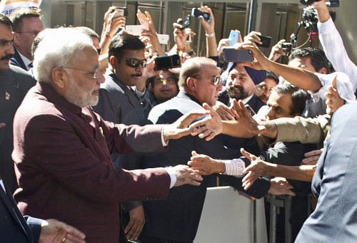 As Narendra Modi plunged into the crowd of fans Friday to respond to their warm welcome of Modi Modi chants and placards greeting him with different messages outside his hotel, the Indian prime minister left the security officials here scurrying after him. PTI photo