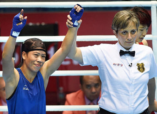 Indian boxer Mary Kom after winning her round of 16 bout against Kim Yeji of Korea in the Women's 51 kg category in Incheon on Saturday. She advanced to the quarter-final with that win. PTI Photo