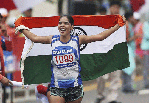 India's Khushbir Kaur holds the tricolour after finishing second in the women's 20km race walk at the 17th Asian Games in Incheon on Sunday. PTI Photo