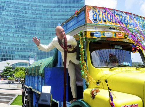 Jeff Bezos, founder and CEO of Amazon, poses as he stands on a supply truck during a photo opportunity at the premises of a shopping mall in the southern Indian city of Bangalore. Reuters