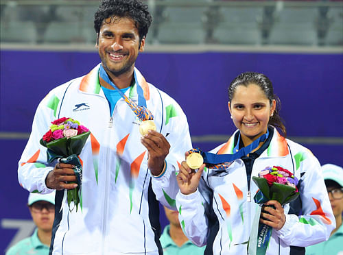 Indian Tennis players Sania Mirza and Saketh Myneni pose with their Gold medals during the medal ceremony of mixed doubles at the 17th Asian Games in Incheon on Monday. PTI Photo