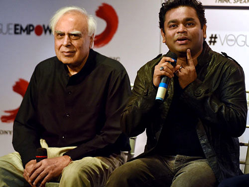 Former union minister Kapil Sibal looks on as music composer A R Rahman speaks during the launch of album Raunaq in Mumbai on Monday. The lyrics in the album are penned by Sibal. PTI Photo