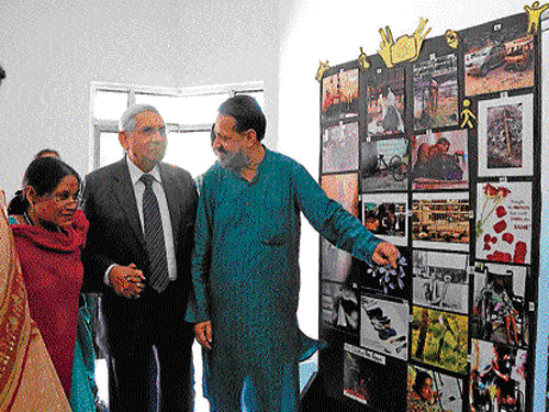 Guests and faculty of the University appreciate the photographs on display.