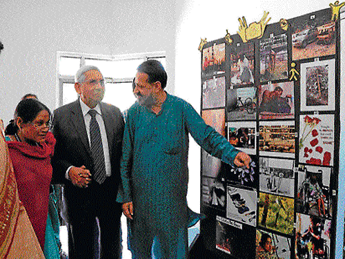 Guests and faculty of the University appreciate the photographs on display.