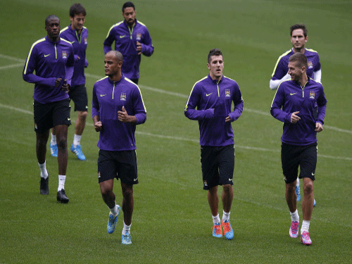 Manchester City players warm up ahead of a training session on the eve of their match against Roma. Reuters
