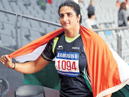 Seema Punia celebrates after her gold medal victory in the women's discus at the Asian Games on Monday. PTI
